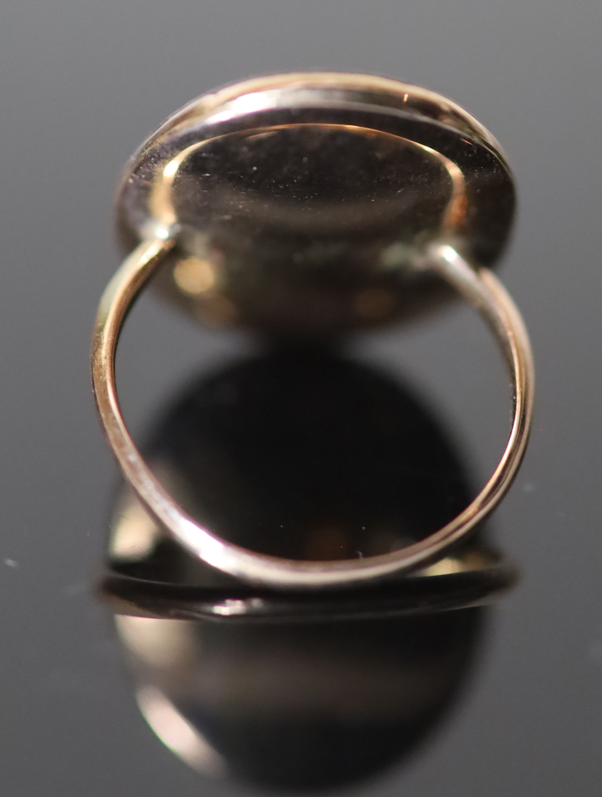 A George III gold and inset oval portrait miniature ring, painted with the bust of a gentleman to sinister,